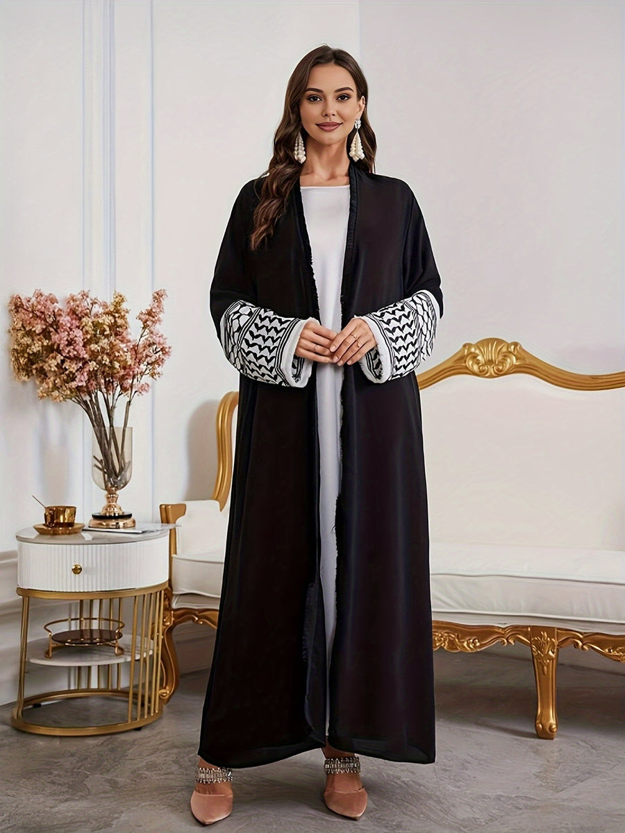A Loose Black And White Embroidered Muslim Dress in a Single Piece - a Dubai-Style Elegant And Conservative Outerwear with Tassels And a Belt Suitable for All Seasons - Black
