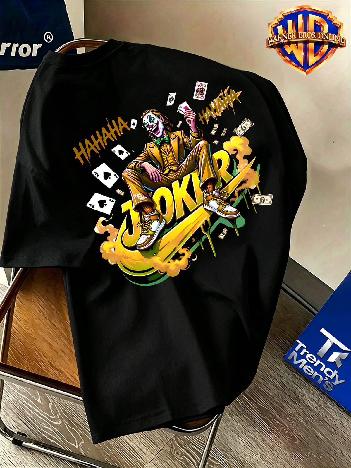 Warner Bros. Official Men's 100% Short-Sleeve T-Shirt, American Cool Vibe with Villain Illustration. Features a Simple Logo on the Chest and a Dynamic Joker Character Depiction on the Back, Incorporating American Streetwear Elements with Bold - Black