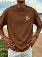 New Men's 100% Pure Cotton T-Shirt with Surfboard, Coconut Tree, and Sun Print, Comfortable and Breathable for Summer Casual Beach Vacations - Coffee Brown