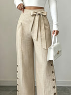 Solid Color Elegant Straight-Leg Wide-Leg Pants with Slit and Button Details. Textured Fabric with a Bow at the Waistband and Side Buttons. Creates a Commuting-appropriate Vibe, Suitable for All Light Casual Outfits in Spring, Summer - Khaki