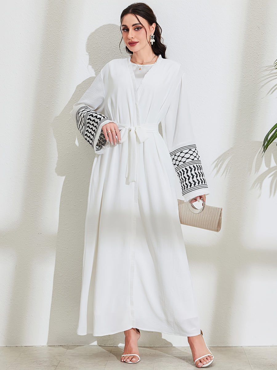 A Loose Black And White Embroidered Muslim Dress in a Single Piece - a Dubai-Style Elegant And Conservative Outerwear with Tassels And a Belt Suitable for All Seasons - White