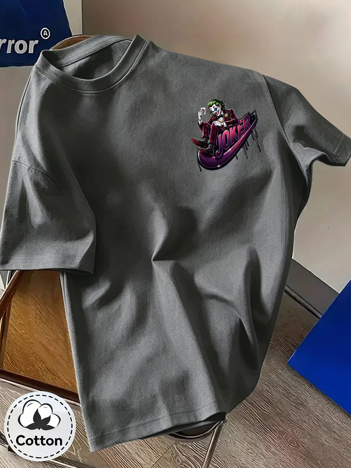 Warner Bros. Official Unisex Summer Loose-Fit Crew Neck Short-Sleeve T-Shirt, Suitable for Daily Commutes, Street Outings, City Trips, and Friend Gatherings. Features a Large Burgundy Suit-wearing Joker Sitting on Purple Graffiti Sneakers - Dark Gray