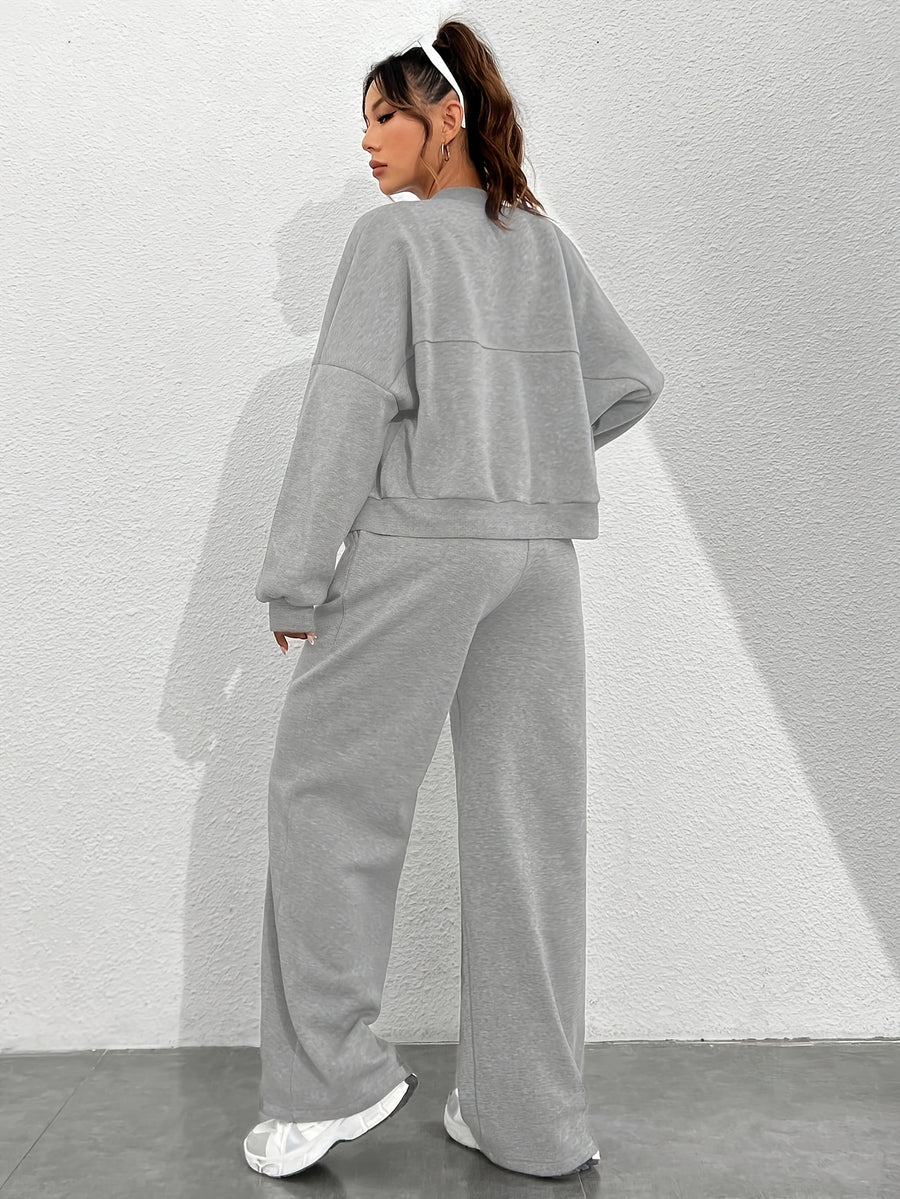 Women's Autumn/Winter Gray Sportswear Set. The Top Features a Hoodless Open-front Zipper Design for Easy on and Off. The Pants Are Matching Gray Sweatpants with an Elastic Waistband and Drawstring for Adjustable Fit. The Versatile Gray Color Is - Light Grey