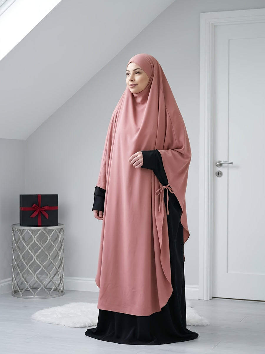 A Solid Color Nidaga Prayer Jilbab. The Fabric Is Skin-friendly and Breathable, Making It Suitable for Women to Wear and Pray Daily. The Robe Abaya Features a 1pc Design with a Khimar, Offering a Strong Drape and a Loose Fit, Ideal for Busy Daily - Pink Color