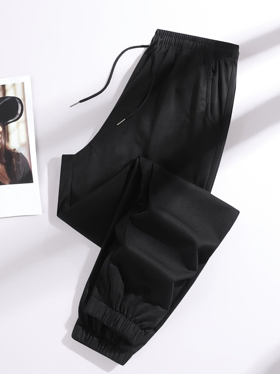 A Pair of Summer Women'S Long Pants, Casual Trousers for Women, Made of And, Featuring Elastic Fabric with Tapered Legs, an Elastic Drawstring at The Waist, Side Pockets, Suitable for Outdoor, Camping, Wear, And Women'S Pants. - Black