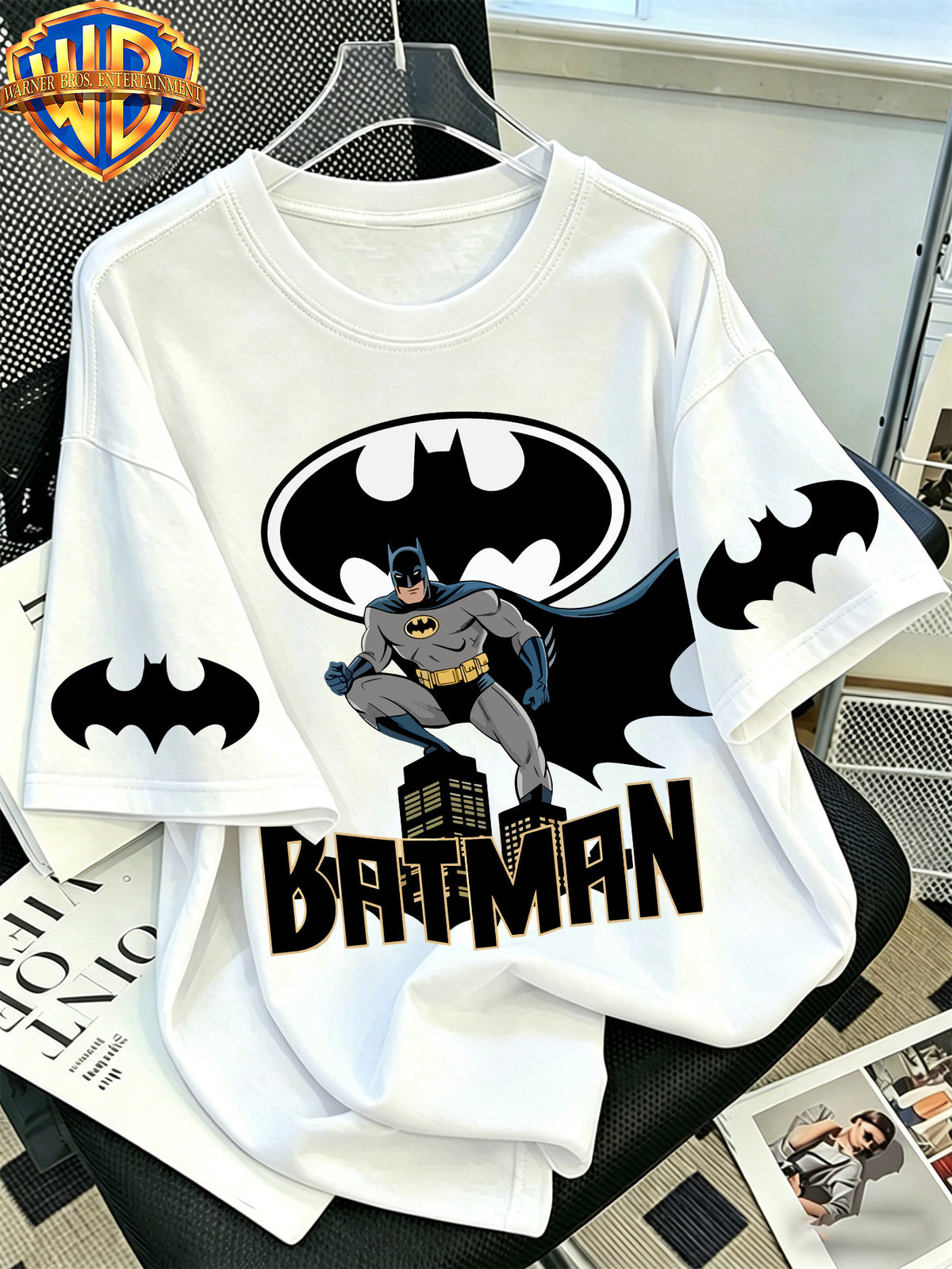Official WB. Men's Short-sleeve T-shirt with Fun Cartoon Print Featuring the DC Batman Logo Character. Round-neck Top Suitable for Men's Casual Summer Daily Commutes, Home Wear, and Office Outfits - White