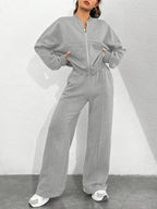 Women's Autumn/Winter Gray Sportswear Set. The Top Features a Hoodless Open-front Zipper Design for Easy on and Off. The Pants Are Matching Gray Sweatpants with an Elastic Waistband and Drawstring for Adjustable Fit. The Versatile Gray Color Is - Light Grey