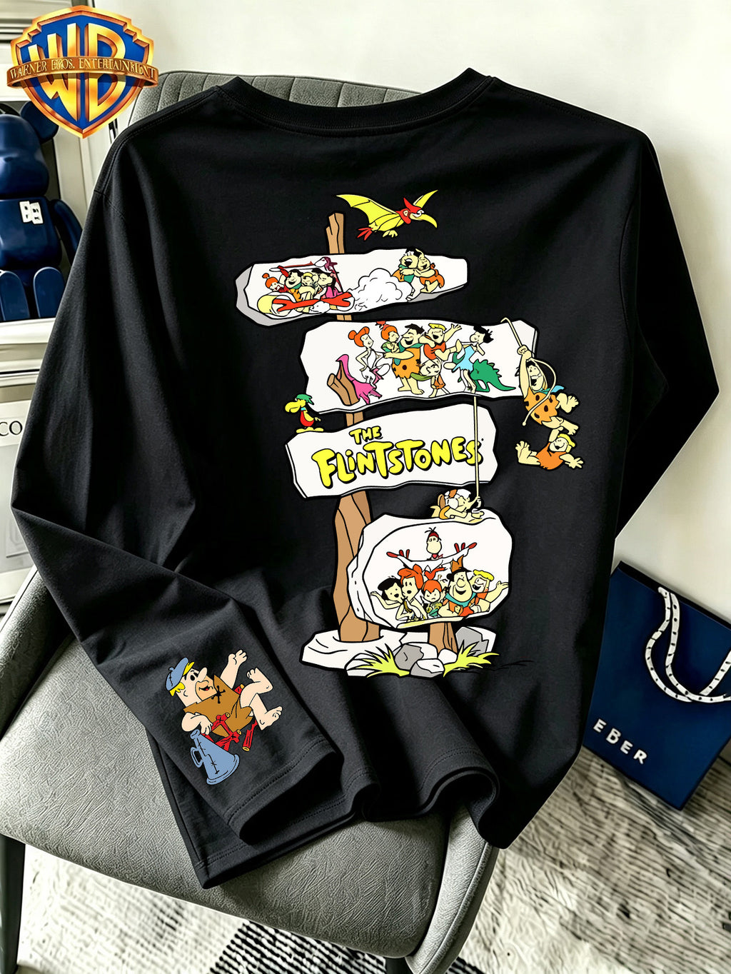 By Warner Bros., Featuring a Lively and Nostalgic Cartoon Print Design with Multiple Scenes of Road Signs, This Men's Comfortable 100% Pure Cotton Long Sleeved T-shirt Is Suitable for Outdoor Sports and Fitness - Black