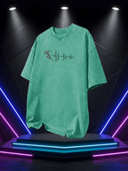 Men's Washed Short-Sleeve T-Shirt, Made of Pure Cotton Fabric That Is Breathable and Skin-friendly. The Relaxed Fit Is Comfortable and Versatile. Features a Creative Print of a Runner on the Front + EKG, Combining Athletic Passion with the Rhythm - Green