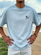 New Men's 100% Pure Cotton T-Shirt with Surfboard, Coconut Tree, and Sun Print, Comfortable and Breathable for Summer Casual Beach Vacations - Light Blue Color