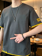 Men's Summer Color-Block 2-in-1 Look Short-Sleeve T-Shirt, Korean-Style Minimalist Casual Crew Neck Top. Features Contrast-color Binding on Both Cuffs and Hem, with Letter-printed Trim at the Hem for Added Detailing. Made from Combed Cotton Fabric - Dark Gray