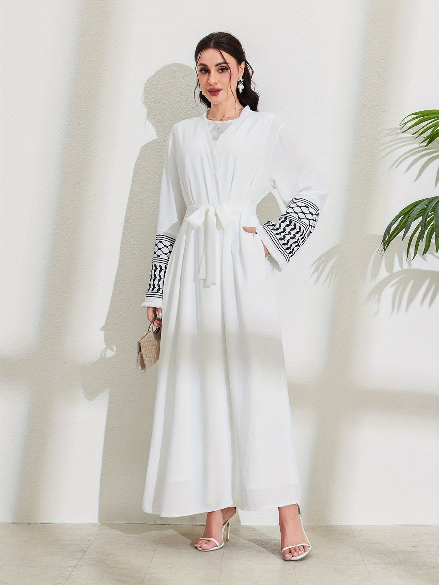 A Loose Black And White Embroidered Muslim Dress in a Single Piece - a Dubai-Style Elegant And Conservative Outerwear with Tassels And a Belt Suitable for All Seasons - White