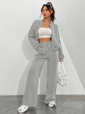 Women's Autumn/Winter Gray Sportswear Set. The Top Features a Hoodless Open-front Zipper Design for Easy on and Off. The Pants Are Matching Gray Sweatpants with an Elastic Waistband and Drawstring for Adjustable Fit. The Versatile Gray Color Is - Light Grey