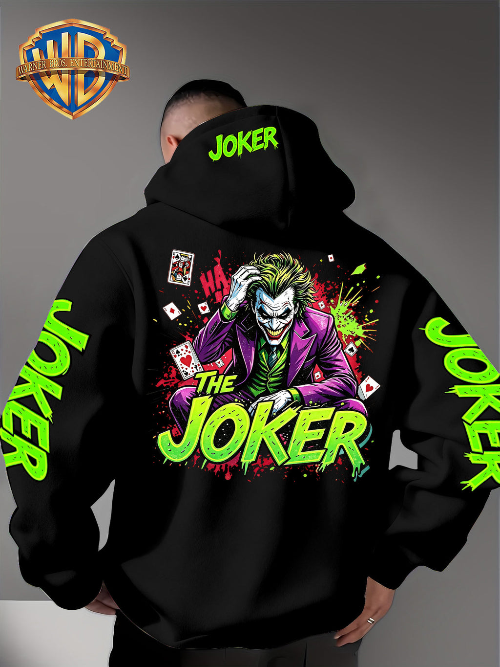 Official Warner Bros. Joker Comic-style Print Featuring Red and Green Ink-splatter Effects and "THE JOKER" Lettering. The Sleeves and Back of the Hood Are Adorned with Green "JOKER" Lettering. This Men's Trendy Printed Hooded Sweatshirt Features - Black