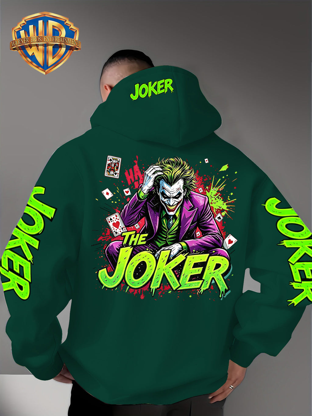 Official Warner Bros. Joker Comic-style Print Featuring Red and Green Ink-splatter Effects and "THE JOKER" Lettering. The Sleeves and Back of the Hood Are Adorned with Green "JOKER" Lettering. This Men's Trendy Printed Hooded Sweatshirt Features - Green