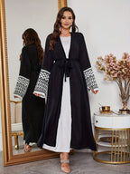 A Loose Black And White Embroidered Muslim Dress in a Single Piece - a Dubai-Style Elegant And Conservative Outerwear with Tassels And a Belt Suitable for All Seasons - Black