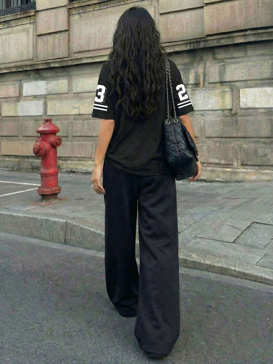 A Two-Piece Set for Women Featuring a Printed Round-Neck Short-Sleeve Top And Loose Drawstring Pants, Perfect for Trendy Summer Streetwear - Black