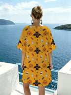 Warm Yellow Halloween Cartoon-themed V-neck Casual Dress, Featuring a Playful and Whimsical Print Combining Pumpkins, Candies, Bats, and Ghosts. The Loose-fit Design with Dropped Shoulders and Short Sleeves Offers Great Figure-flattering Versatility. - Mixed colors