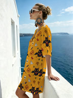 Warm Yellow Halloween Cartoon-themed V-neck Casual Dress, Featuring a Playful and Whimsical Print Combining Pumpkins, Candies, Bats, and Ghosts. The Loose-fit Design with Dropped Shoulders and Short Sleeves Offers Great Figure-flattering Versatility. - Mixed colors