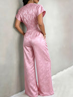 New Spring/Summer 2026 Women's Jacquard Short-Sleeve Jumpsuit with Subtle Butterfly Pattern, V-Neck, Cinched Waist, and Wide-Leg Pants. This Light Luxury, High-end Jumpsuit Offers a Sophisticated Look for Commuting. The Simple and Exquisite V-neck - Pink Color