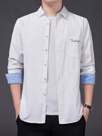 Men's Oxford Cloth Long-Sleeve Shirt for Spring/Autumn, with Lapel Collar, Simple Pocket, and English Print Decoration. Features Contrast Color Cuffs and Collar Design. A Versatile Basic Shirt for Business Casual Wear, Available in Multiple Colors - White