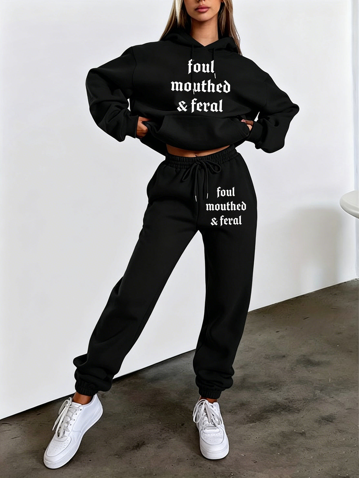 Autumn/Winter Trendy Fashion Women's Hooded Drawstring Sweatshirt and Sweatpants Set. Features a Hooded Drawstring Design and a Front Kangaroo Pocket on the Sweatshirt for Comfortable Cold-weather Wear. Classic Silhouette with a Comfortable Fit. - Black
