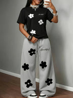 Spring/Summer New Set: 2pcs Outfit Featuring Hand-drawn Floral Print, Multi-color Round-neck Short-sleeve Top and Loose-fit Drawstring Straight-leg Pants. A Fashionable Y2K Streetwear Style with Hip-hop Y Vibes, Perfect for Summer Streetwear - Black+gray