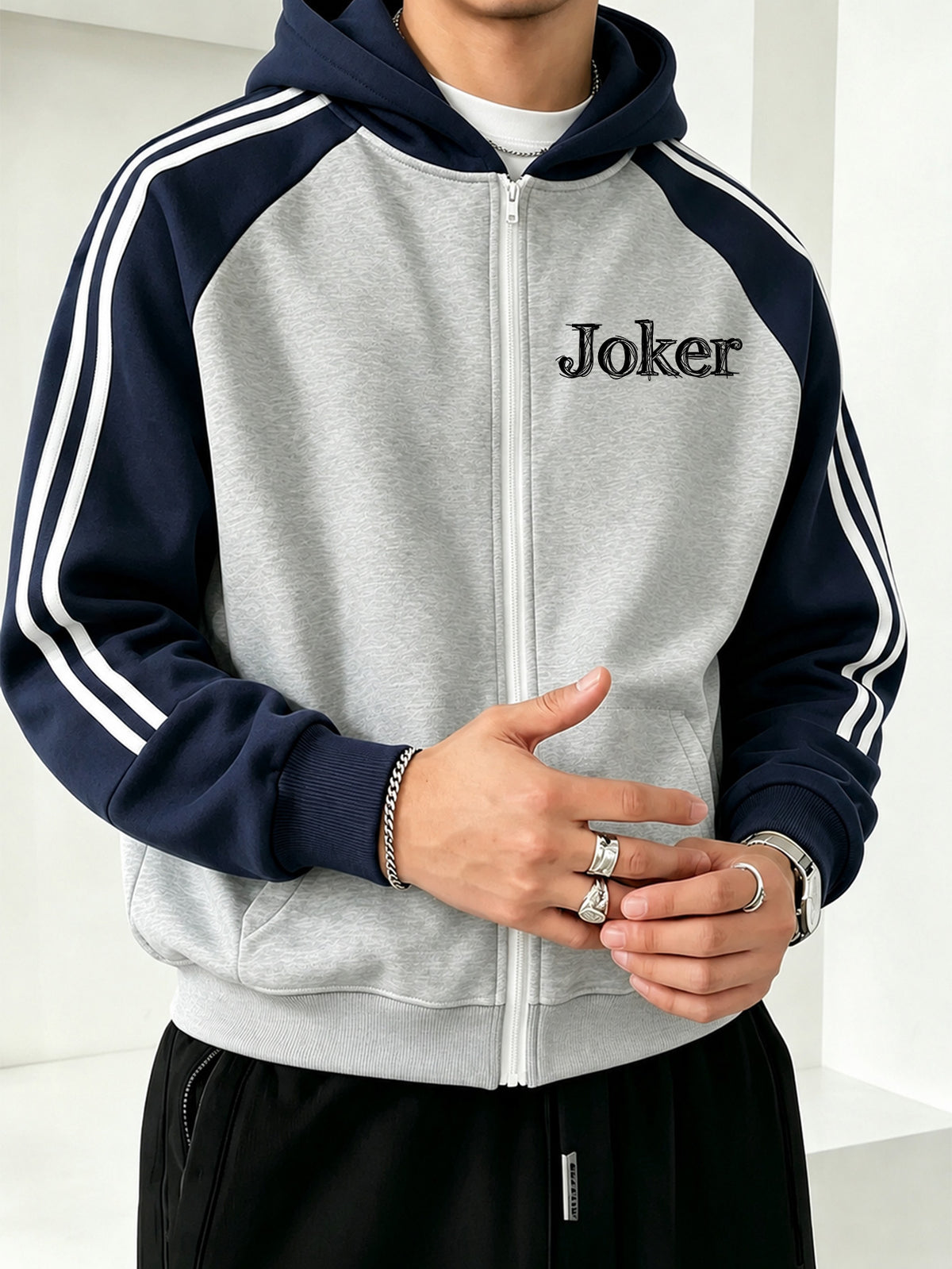 Officially Licensed by Warner Bros., This New Men'S Fashion Hoodie Features a Color-Block Design with a Printed Sketch of The Joker'S Face. A Zipped Hooded Jacket for Autumn And Winter, It Boasts a Relaxed Fit And Is Made from Comfortable Fabric - Grey-blue