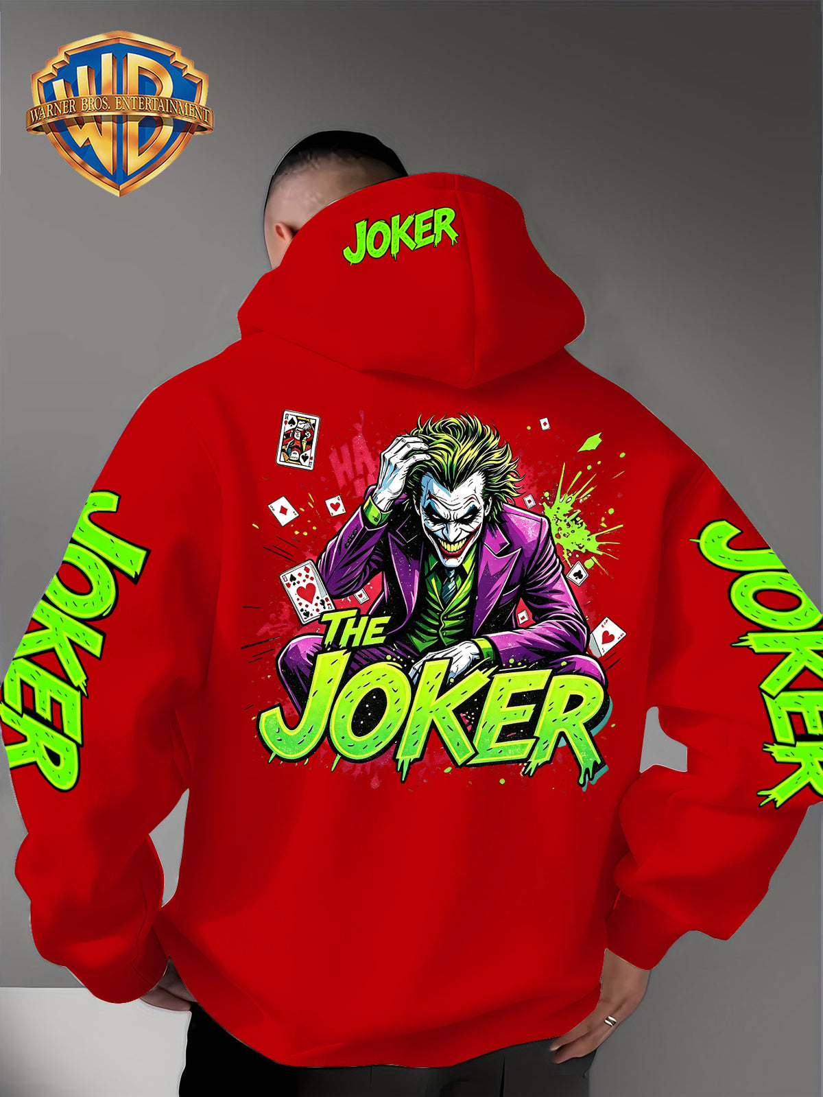Official Warner Bros. Joker Comic-style Print Featuring Red and Green Ink-splatter Effects and "THE JOKER" Lettering. The Sleeves and Back of the Hood Are Adorned with Green "JOKER" Lettering. This Men's Trendy Printed Hooded Sweatshirt Features - Red