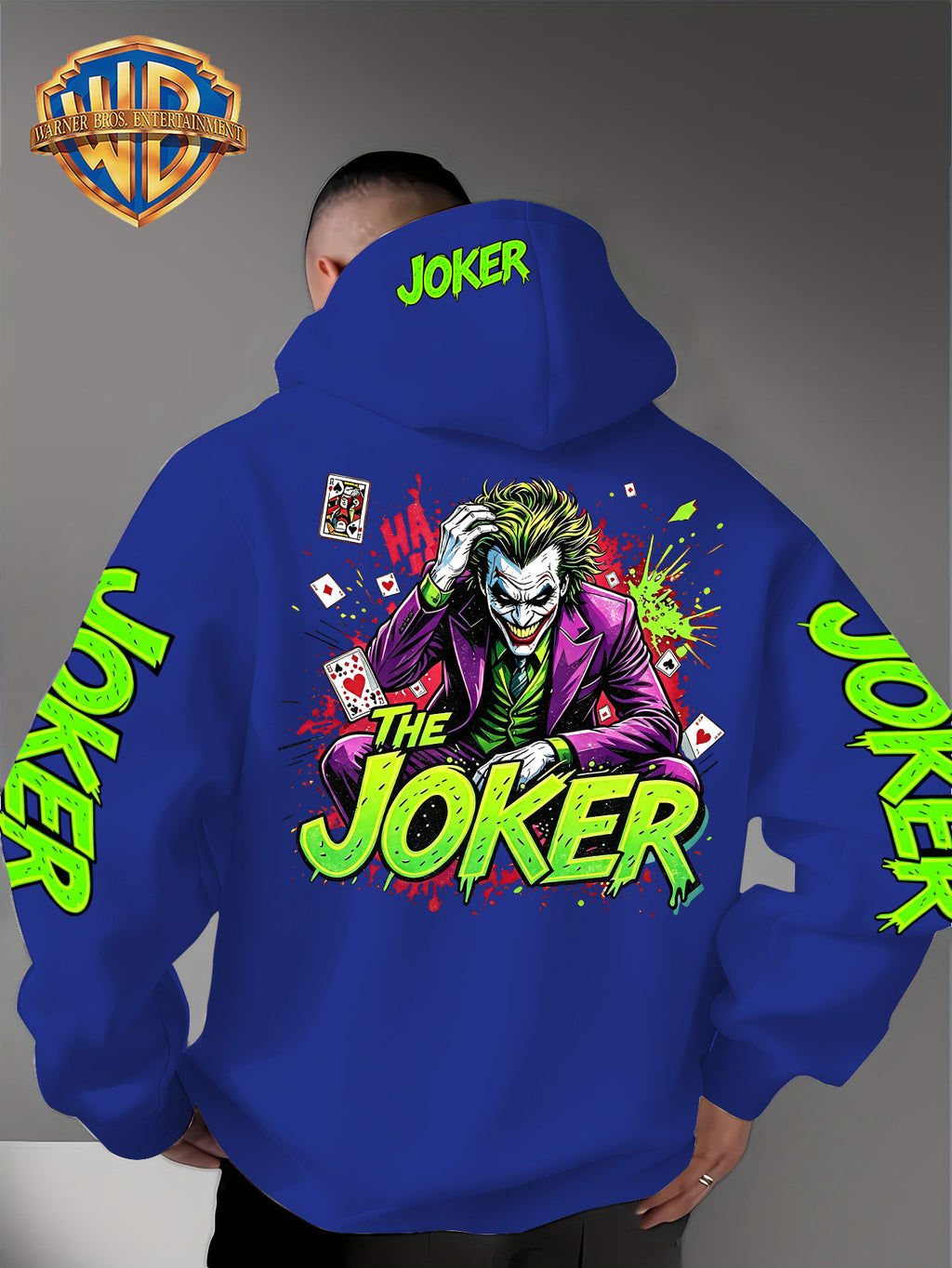 Official Warner Bros. Joker Comic-style Print Featuring Red and Green Ink-splatter Effects and "THE JOKER" Lettering. The Sleeves and Back of the Hood Are Adorned with Green "JOKER" Lettering. This Men's Trendy Printed Hooded Sweatshirt Features - Blue
