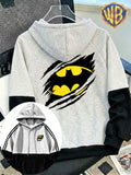 WB Men's Batman Logo Hooded Sweatshirt Jacket - Warner Bros. Official Merchandise, Torn Claw Bat Emblem Front & Back Print, Color Block Spliced Hoodie with Kangaroo Pocket, Loose Fit Pullover Suitable for All Seasons, Machine Washable Gift - Black And Grey