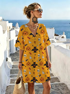 Warm Yellow Halloween Cartoon-themed V-neck Casual Dress, Featuring a Playful and Whimsical Print Combining Pumpkins, Candies, Bats, and Ghosts. The Loose-fit Design with Dropped Shoulders and Short Sleeves Offers Great Figure-flattering Versatility. - Mixed colors