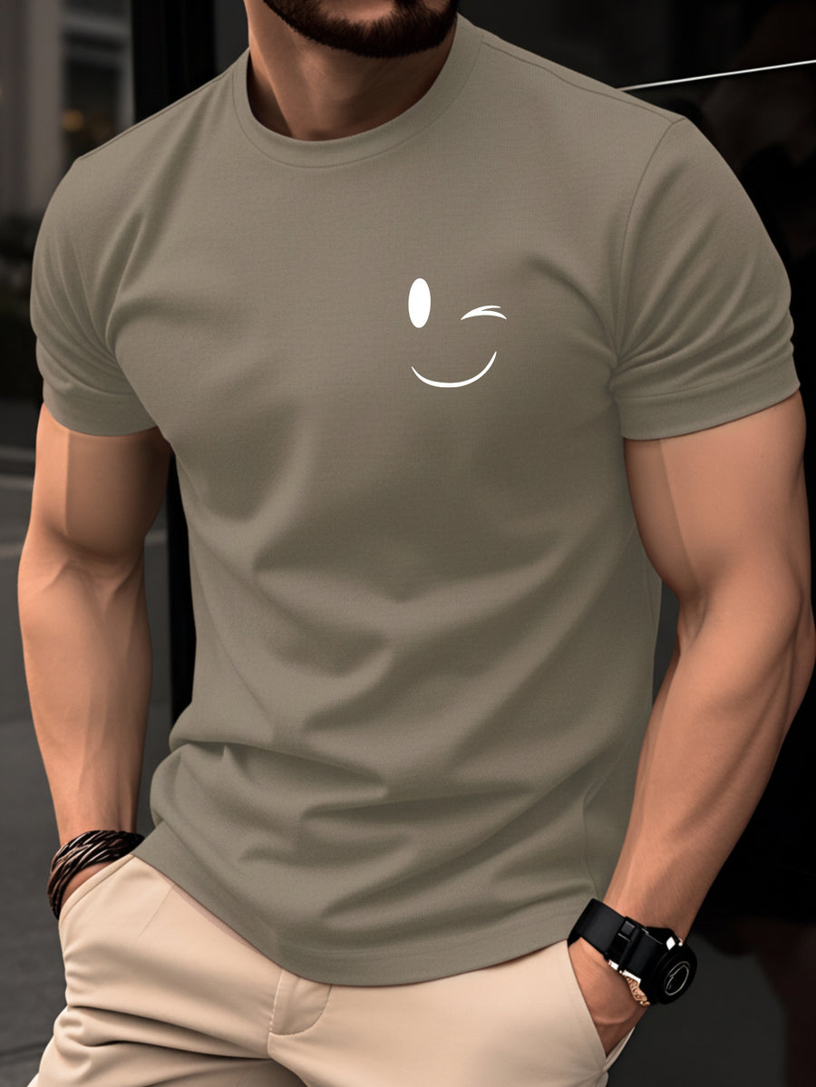 100% Cotton Men's T-Shirt, Summer Short Sleeve Thin Top, Trendy Fashion Slim Fit Youth Daily Casual Versatile 2026 New Year Holiday Outfit, Simple Line Joyful Face Pattern with Playful Winking Expression Design for Added Fun - Khaki