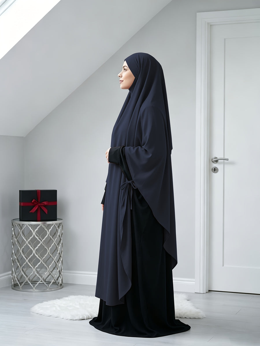 A Solid Color Nidaga Prayer Jilbab. The Fabric Is Skin-friendly and Breathable, Making It Suitable for Women to Wear and Pray Daily. The Robe Abaya Features a 1pc Design with a Khimar, Offering a Strong Drape and a Loose Fit, Ideal for Busy Daily - Navy Color