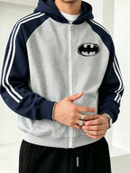 Officially Licensed by Warner Bros., This New Men's Colour-blocked Fashion Hoodie Features a Batman Logo Print with a Brushstroke Border. A Zipped Hooded Jacket for Autumn and Winter, It Has a Relaxed Fit and Is Made from Comfortable Fabric. - Grey-blue